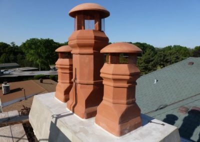 Three Terracotta Mushroom Chimney Caps with Newly Poured Chimney Crown