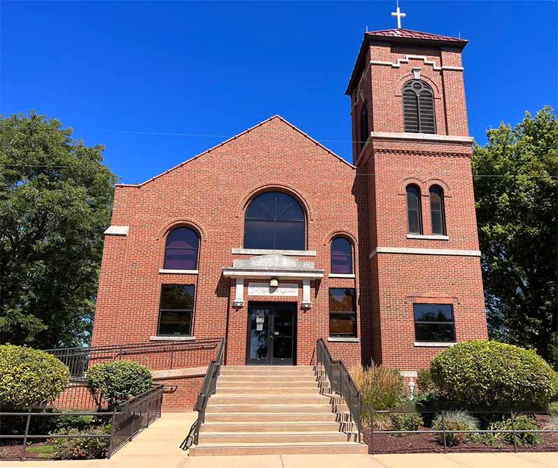Leonard & Sons -M Original image of tuckpointing on church red brick church surrounded by trees